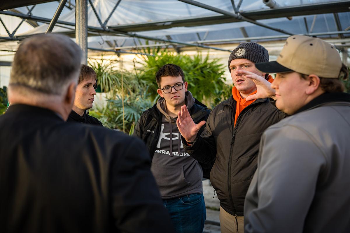 Students in Northwest's Internet of Things course, with faculty and staff on Wednesday, discussed the monitoring system they built to better maintain plant life in University greenhouses. (Photo by Lilly Cook/Northwest Missouri State University)